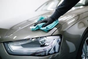 Man Car Detailing, Cleaning Car With Microfiber Cloth.