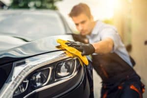 Car Detailing Man Holds The Microfiber In Hand.