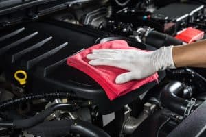 Car Detailing. Car Detailing Series Cleaning Car Engine. Man hand holding cloth cleaning engine.