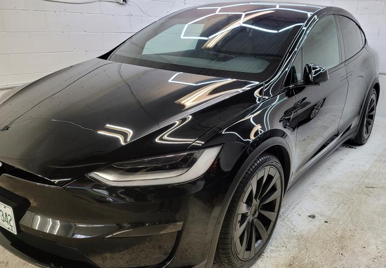 Black Tesla Model X with a glossy professionally coated finish