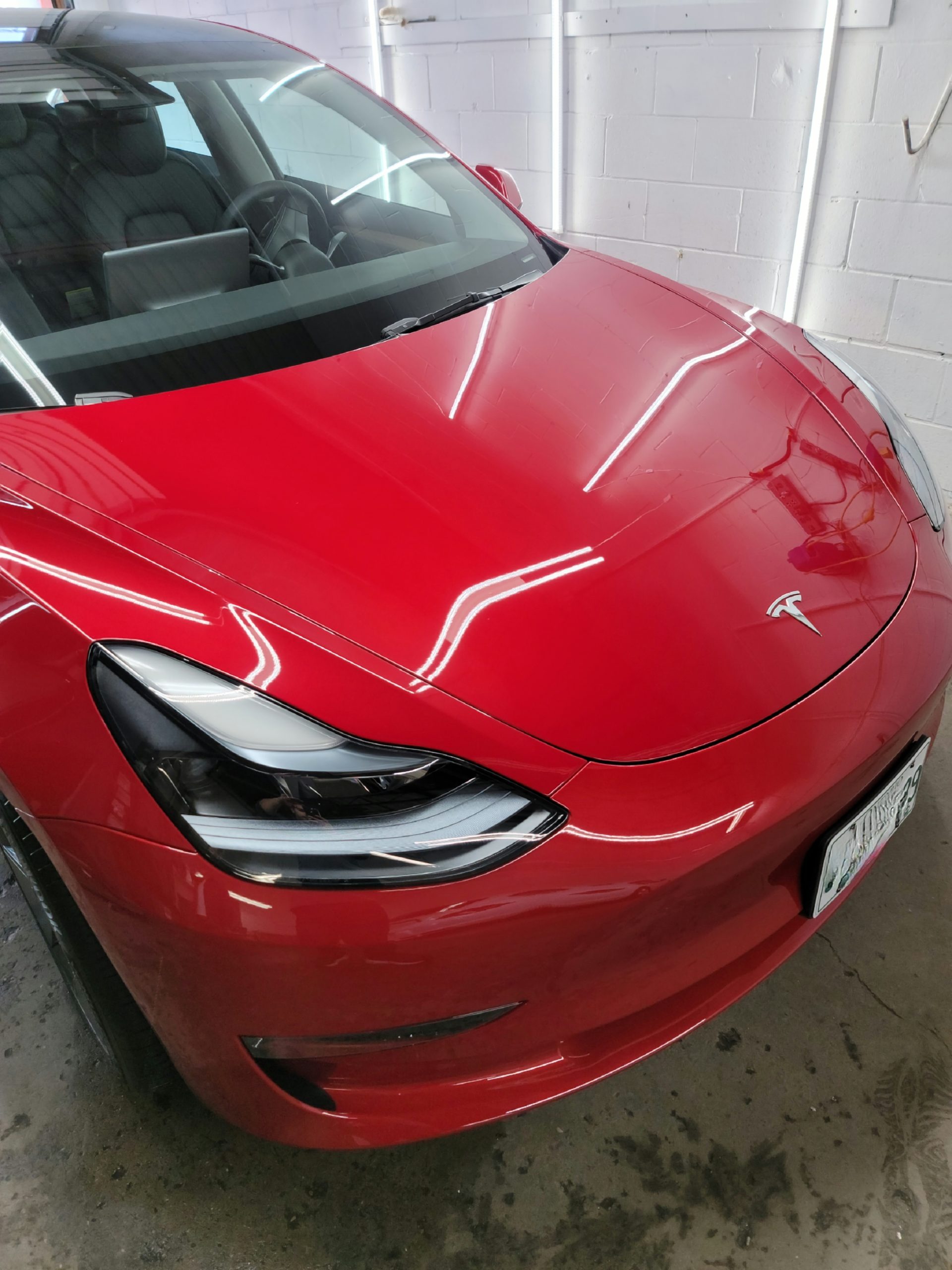 Red Tesla Model 3 with ceramic coating applied by MNV Auto Detailing