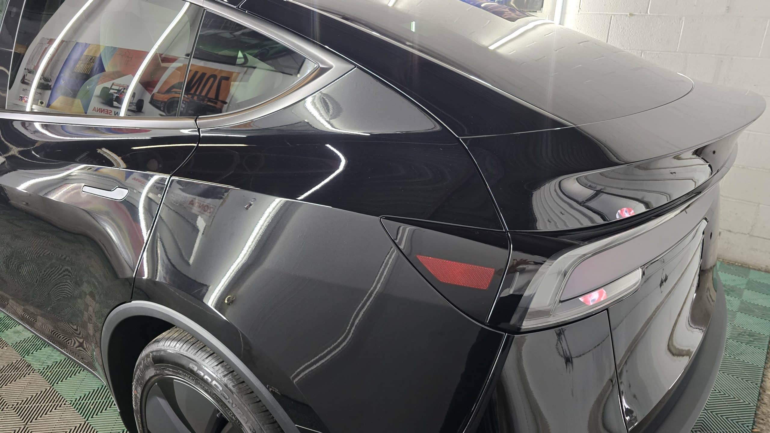 Close view of Tesla paint after ceramic coating at MNV Auto Detailing showing exceptional gloss and clarity
