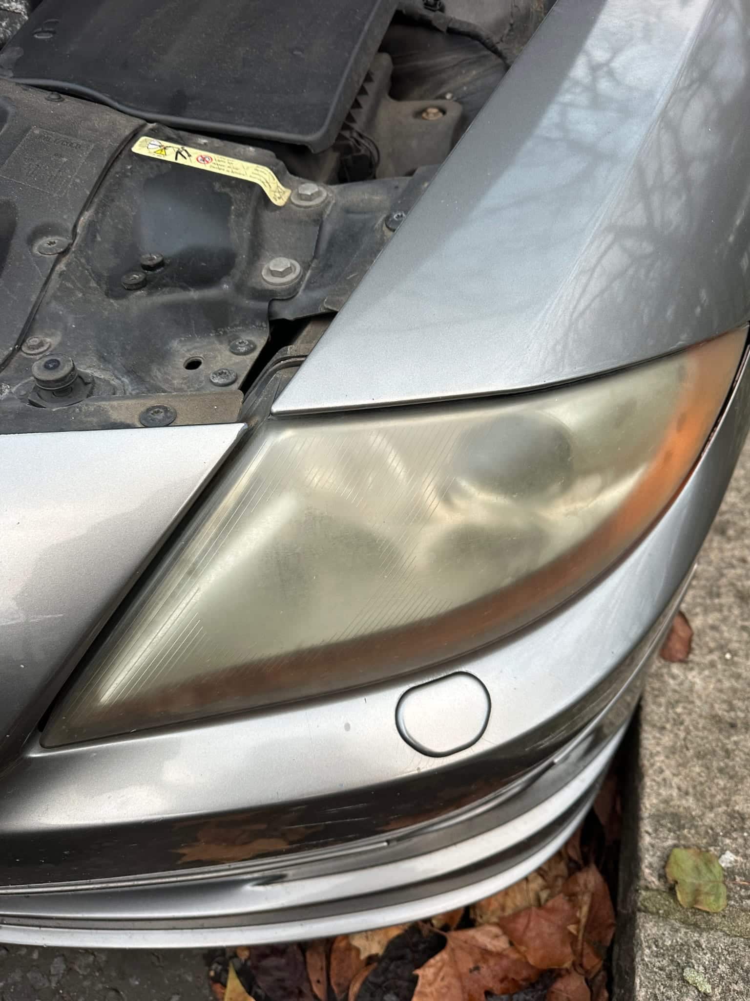 Cloudy and oxidized vehicle headlight before restoration at MNV Auto Detailing